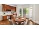 Bright dining area with hardwood floors and large windows, features a dining table set for four at 15216 Ballantyne Country Club Dr, Charlotte, NC 28277