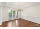 Elegant dining room with hardwood floors, classic trim and a beautiful chandelier at 15216 Ballantyne Country Club Dr, Charlotte, NC 28277