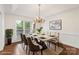 Elegant dining room with modern table, chandelier, and natural light at 15216 Ballantyne Country Club Dr, Charlotte, NC 28277