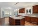 Bright kitchen with wooden cabinets, island cooktop, and ample counter space at 15216 Ballantyne Country Club Dr, Charlotte, NC 28277