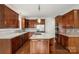 Well-equipped kitchen with stainless steel appliances, island, and wooden cabinets at 15216 Ballantyne Country Club Dr, Charlotte, NC 28277