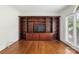 Room features built-in shelving, hardwood floors, and large window at 15216 Ballantyne Country Club Dr, Charlotte, NC 28277