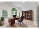 Home office with large windows and custom bookcase perfect for work and study at 15216 Ballantyne Country Club Dr, Charlotte, NC 28277