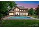 Beautiful backyard oasis with a sparkling pool, lounge chairs, and manicured lawn at 15216 Ballantyne Country Club Dr, Charlotte, NC 28277