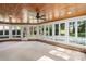 Charming sunroom with wood ceiling, fan, many windows and brick accents at 15216 Ballantyne Country Club Dr, Charlotte, NC 28277