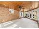 Inviting sunroom with wood ceiling, brick wall, fan, and large windows at 15216 Ballantyne Country Club Dr, Charlotte, NC 28277