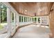 Bright sunroom with wood ceiling, brick accents and numerous windows overlooking the pool at 15216 Ballantyne Country Club Dr, Charlotte, NC 28277