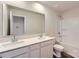 Bright bathroom features a double sink vanity with white countertops and a tub with white shower surround at 1545 Cottage Creek Dr, Bessemer City, NC 28016