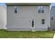 Rear exterior of home with light gray siding, and a door with small concrete steps at 1545 Cottage Creek Dr, Bessemer City, NC 28016