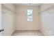 Walk-in closet with carpeted flooring, wire shelving, and a window that provides natural light to the storage space at 1545 Cottage Creek Dr, Bessemer City, NC 28016