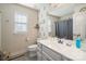 Bathroom with white cabinets and a gray accent wall at 1708 Speartip Ln, Denver, NC 28037