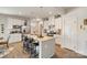 Bright kitchen featuring white cabinets, stainless steel appliances, and a large island with bar seating at 1708 Speartip Ln, Denver, NC 28037