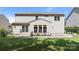 Spacious backyard with lush green grass, a stone patio, and a home featuring horizontal siding at 1814 Still Water Ln, Fort Mill, SC 29707