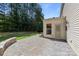 A patio with beautiful stonework is nestled in a lush backyard with mature trees at 1814 Still Water Ln, Fort Mill, SC 29707