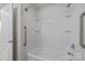 Features a white bathtub and shower combination with safety grab bars inside a well-lit bathroom at 1814 Still Water Ln, Fort Mill, SC 29707