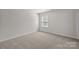 Cozy bedroom showing neutral carpet, bright natural light from the window at 1814 Still Water Ln, Fort Mill, SC 29707