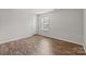 Bedroom with wood flooring, window, and white painted walls at 1814 Still Water Ln, Fort Mill, SC 29707