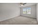A carpeted bedroom features a ceiling fan and a bright window allowing for natural light at 1814 Still Water Ln, Fort Mill, SC 29707