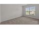 Neutral bedroom with plush carpet, a large window, and ample natural light at 1814 Still Water Ln, Fort Mill, SC 29707