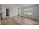 A bedroom with wood floors, a ceiling fan, bright windows, and an open door at 1814 Still Water Ln, Fort Mill, SC 29707