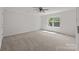 Spacious bedroom featuring neutral carpet, ceiling fan, and bright natural light from the window at 1814 Still Water Ln, Fort Mill, SC 29707