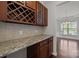 Butler pantry featuring granite countertops, custom cabinets, and a wine rack at 1814 Still Water Ln, Fort Mill, SC 29707