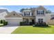 Charming two-story home with a well-manicured lawn, neutral siding, and an attached two-car garage at 1814 Still Water Ln, Fort Mill, SC 29707