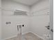 A laundry room features a sink and shelving, offering functional space for household chores at 1814 Still Water Ln, Fort Mill, SC 29707