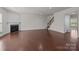 Open living room with hardwood floors, fireplace, staircase, and lots of natural light at 1814 Still Water Ln, Fort Mill, SC 29707