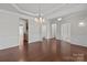 Spacious living room with hardwood floors, wainscoting, tray ceiling, and chandelier at 1814 Still Water Ln, Fort Mill, SC 29707