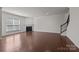 Open living room with hardwood floors, fireplace, staircase, and lots of natural light at 1814 Still Water Ln, Fort Mill, SC 29707
