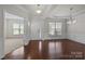 Bright living room featuring hardwood floors, large windows, and elegant trim work at 1814 Still Water Ln, Fort Mill, SC 29707