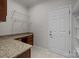 Mudroom with granite countertop desk, white door, wire shelving, and tile flooring at 1814 Still Water Ln, Fort Mill, SC 29707