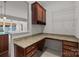 Office space with a desk, drawers, cabinets, and views of the kitchen and sunroom at 1814 Still Water Ln, Fort Mill, SC 29707