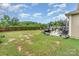 Large backyard with an expansive lawn, a barbecue area, and a wooden fence with tree line in the distance at 189 Fesperman Cir, Troutman, NC 28166