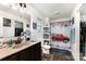 Bright bathroom with a car-themed shower curtain, dark vanity, and a large mirror for grooming at 189 Fesperman Cir, Troutman, NC 28166