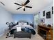 Serene primary bedroom featuring a ceiling fan, cozy bench, exercise bike, and an elegant accent wall at 189 Fesperman Cir, Troutman, NC 28166