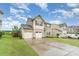 Beautiful two-story home featuring a spacious driveway, two car garage, and manicured front yard at 189 Fesperman Cir, Troutman, NC 28166