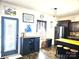 Well-lit kitchen with dark cabinets, stainless steel appliances, and a breakfast bar with seating at 189 Fesperman Cir, Troutman, NC 28166