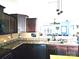 Open-concept kitchen with dark cabinetry, granite countertops, and modern appliances leading to the living area at 189 Fesperman Cir, Troutman, NC 28166