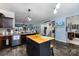 Open kitchen featuring a central island with seating, modern appliances, and a view to the living area at 189 Fesperman Cir, Troutman, NC 28166