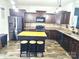Modern kitchen with dark cabinetry, stainless steel appliances, a central island, and stylish pendant lighting at 189 Fesperman Cir, Troutman, NC 28166