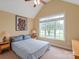 Bedroom with large window, vaulted ceilings, and neutral colors at 1912 Windmere Dr, Monroe, NC 28110