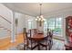 Elegant dining room featuring a chandelier, large window, and hardwood floors at 1912 Windmere Dr, Monroe, NC 28110