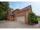 Brick home exterior showcases a large garage, well-manicured landscaping, and an inviting entryway at 1912 Windmere Dr, Monroe, NC 28110
