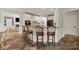 Kitchen island features a granite countertop, white cabinets and barstool seating at 1912 Windmere Dr, Monroe, NC 28110