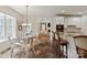 Open kitchen featuring a glass table, kitchen island with barstools and view of the living room at 1912 Windmere Dr, Monroe, NC 28110