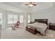 Bright main bedroom featuring a large window and a seating area with recliner at 1912 Windmere Dr, Monroe, NC 28110