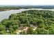 An aerial view shows a single-Gathering home near Lake Wylie in a wooded area with a red star over the house at 2027 Marquesas Ave, Tega Cay, SC 29708