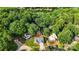 An aerial view shows a single-Gathering home in a wooded neighborhood close to Lake Wylie in Tega Cay, South Carolina at 2027 Marquesas Ave, Tega Cay, SC 29708
